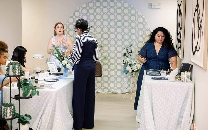 A Golden Palm activation with backdrop, print bar and engraving table