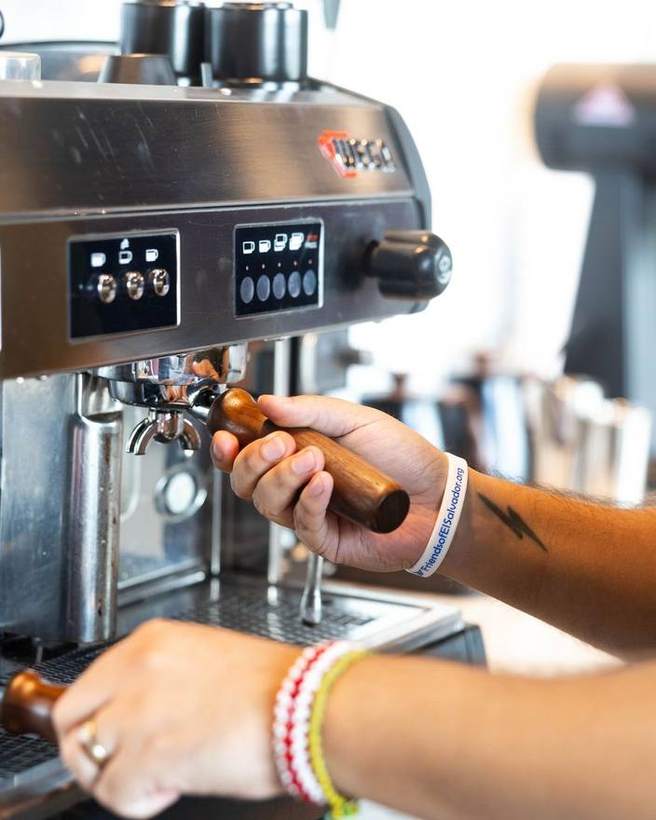 A barista pulling a shot at Obsidian Coffee