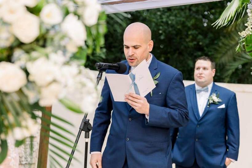 A groom reading during the ceremony