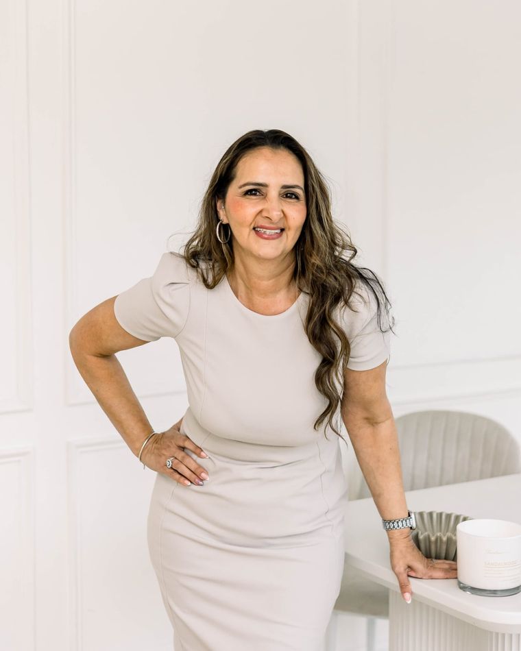 A business owner standing by a console table during a personal branding session