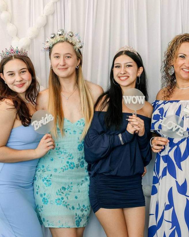 Guests photographed with props at a Golden Palm activation