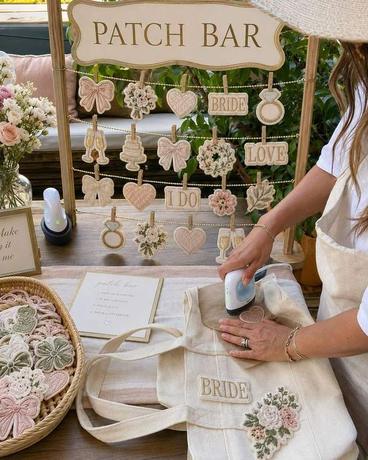 Chenille letter patches pressed onto totes at a Golden Palm patch bar
