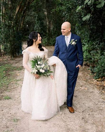 A groom carrying the bride's veil at a Fort Lauderdale wedding