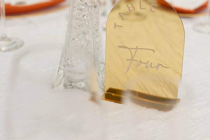 A gilded escort card at a wedding reception