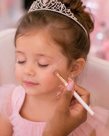 Face gems set by hand beside a guest's eye