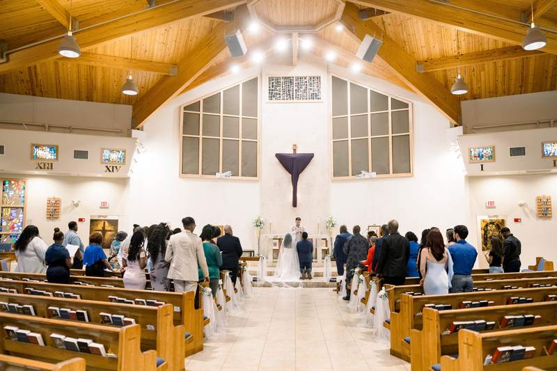 A church wedding ceremony seen from the back of the aisle