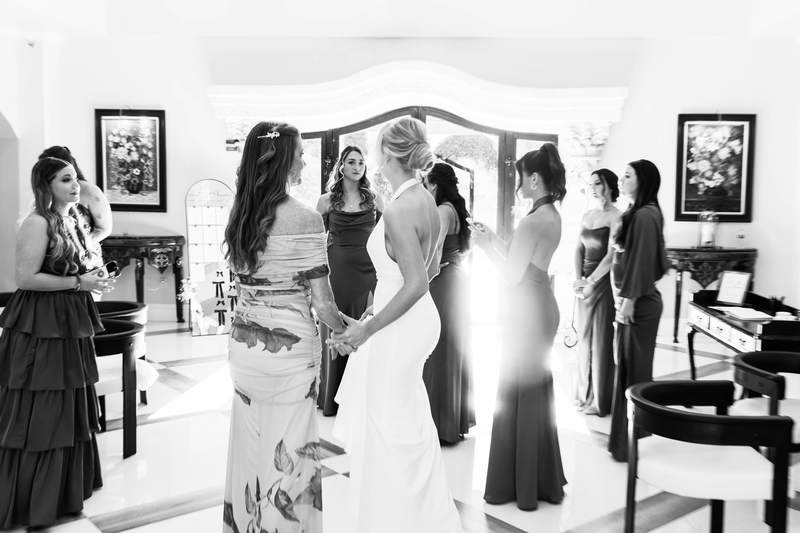 Black and white, a bride and her bridesmaids together before the ceremony