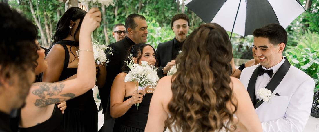 Bridesmaids reacting as the bride turns to them before the ceremony